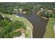 Scenic aerial view of a golf course and lake surrounded by lush trees and luxury homes in a beautiful community at 1023 Little Darby Ln, Suwanee, GA 30024