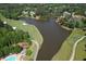 Aerial view highlighting the golf course and water features, showcasing the recreational amenities of this community at 1023 Little Darby Ln, Suwanee, GA 30024