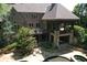 Spacious backyard featuring a covered porch, pool and spa surrounded by lush landscaping for ultimate privacy at 1023 Little Darby Ln, Suwanee, GA 30024