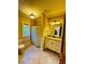 Bathroom featuring vanity with granite countertops, tiled floors, and a shower with patterned curtain at 1023 Little Darby Ln, Suwanee, GA 30024