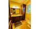 This bathroom features dark wood cabinets, granite countertops, a large mirror, and travertine tile floors at 1023 Little Darby Ln, Suwanee, GA 30024