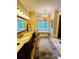 Bright bathroom features a soaking tub, chandelier, double vanity with granite countertops, and travertine tile floors at 1023 Little Darby Ln, Suwanee, GA 30024