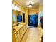 Bathroom featuring stylish vanity lighting fixtures, granite countertops, tiled floors and shower with patterned curtain at 1023 Little Darby Ln, Suwanee, GA 30024