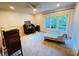 Bedroom featuring a chaise lounge and ample natural light from the large window at 1023 Little Darby Ln, Suwanee, GA 30024