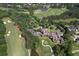 Aerial view of clubhouse situated on a golf course with a lake and manicured grounds at 1023 Little Darby Ln, Suwanee, GA 30024