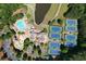 Overhead view of a pool and tennis courts in a well-maintained community with a lush landscape and water access at 1023 Little Darby Ln, Suwanee, GA 30024