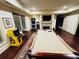 Spacious game room featuring a pool table, arcade games, and a fireplace, ideal for entertaining guests at 1023 Little Darby Ln, Suwanee, GA 30024