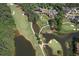 Aerial view of a golf course with ponds and bridges in a lush, green setting at 1023 Little Darby Ln, Suwanee, GA 30024