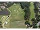 Aerial view of pristine golf course featuring manicured greens, sand traps and lush landscaping at 1023 Little Darby Ln, Suwanee, GA 30024