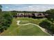 Scenic view of a long green with trees and a brown, modern home in the background at 1023 Little Darby Ln, Suwanee, GA 30024
