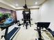 Stay fit in this private home gym equipped with modern exercise machines and a scenic mural at 1023 Little Darby Ln, Suwanee, GA 30024