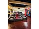 Luxurious home theater with leather recliners, a projector screen, a wet bar, and hardwood floors at 1023 Little Darby Ln, Suwanee, GA 30024
