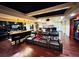 Luxurious home theater with leather recliners, a projector screen, a wet bar, and dark hardwood floors at 1023 Little Darby Ln, Suwanee, GA 30024