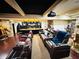 Luxurious home theater features leather recliners, a projector screen, a wet bar, and movie memorabilia at 1023 Little Darby Ln, Suwanee, GA 30024