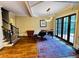 Inviting living room featuring a grand piano, hardwood floors, and access to an outdoor space at 1023 Little Darby Ln, Suwanee, GA 30024