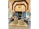 Spacious living room with a stone fireplace, high ceilings, and lots of natural light at 1023 Little Darby Ln, Suwanee, GA 30024