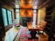 Office boasts wood-paneled walls, a fireplace, built-in bookshelves, hardwood floors, and an ornate desk at 1023 Little Darby Ln, Suwanee, GA 30024