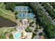 Aerial view showcasing tennis courts and a community pool with lush landscaping, perfect for outdoor recreation at 1023 Little Darby Ln, Suwanee, GA 30024