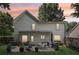 Home's backyard features a patio with seating, a grill, and a lawn area at 3388 Washington Cmns Nw Ave, Kennesaw, GA 30144