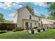 Well-maintained backyard with patio furniture, lush lawn, and mature trees for privacy and shade at 3388 Washington Cmns Nw Ave, Kennesaw, GA 30144