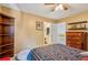 Bedroom features a ceiling fan, wood furniture, and an open doorway leading to the bathroom at 3388 Washington Cmns Nw Ave, Kennesaw, GA 30144