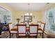 Formal dining room with hardwood floors, chandelier, and large window, perfect for entertaining at 3388 Washington Cmns Nw Ave, Kennesaw, GA 30144
