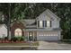 Traditional home features brick accents, a two-car garage, and manicured landscaping at 3388 Washington Cmns Nw Ave, Kennesaw, GA 30144