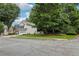 Corner lot home with green lawn, mature trees, and a two-car attached garage at 3388 Washington Cmns Nw Ave, Kennesaw, GA 30144