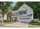 Traditional two-story home boasts a brick accent, attached garage, and manicured lawn at 3388 Washington Cmns Nw Ave, Kennesaw, GA 30144