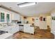 Bright kitchen with stainless steel appliances, white cabinets, and hardwood floors at 3388 Washington Cmns Nw Ave, Kennesaw, GA 30144