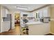 Well-lit kitchen with white cabinets, stainless steel appliances, and access to the dining room at 3388 Washington Cmns Nw Ave, Kennesaw, GA 30144