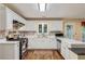 Bright kitchen with white cabinets, modern appliances, and ample counter space at 3388 Washington Cmns Nw Ave, Kennesaw, GA 30144