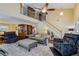 Open-concept living room with hardwood floors, staircase, vaulted ceiling, and comfortable seating at 3388 Washington Cmns Nw Ave, Kennesaw, GA 30144