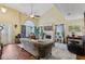 Elegant living room with vaulted ceiling, fireplace, hardwood floors, and plenty of natural light at 3388 Washington Cmns Nw Ave, Kennesaw, GA 30144