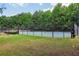 Community tennis courts surrounded by high fences and lush green trees, lit by lampposts on green lawns at 3388 Washington Cmns Nw Ave, Kennesaw, GA 30144
