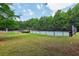 Community tennis courts and playground area in a fenced area with green lawns and mature trees at 3388 Washington Cmns Nw Ave, Kennesaw, GA 30144