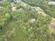 Aerial view of property featuring a house surrounded by lush greenery, offering privacy and a natural setting at 379 Bohannon Rd, Grantville, GA 30220