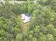 Aerial view of a house nestled among dense trees, highlighting its secluded location and expansive property at 379 Bohannon Rd, Grantville, GA 30220