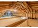 Unfinished attic space with exposed wooden beams and rafters, perfect for storage or conversion at 379 Bohannon Rd, Grantville, GA 30220
