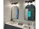 Bright bathroom featuring double sink vanity, wood-look accent wall, and modern lighting fixtures at 379 Bohannon Rd, Grantville, GA 30220
