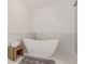 Luxurious bathroom showcasing a freestanding tub, marble accents, shiplap wall, and a stylish rug at 379 Bohannon Rd, Grantville, GA 30220
