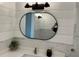 A modern bathroom featuring a unique oval mirror, white counter, and shiplap walls at 379 Bohannon Rd, Grantville, GA 30220