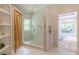 Modern bathroom features a glass enclosed shower with pebble floor and shiplap accent wall at 379 Bohannon Rd, Grantville, GA 30220