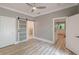 Bedroom showcasing wood-look floors and sliding barn door leading into the bathroom at 379 Bohannon Rd, Grantville, GA 30220