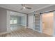 Open-concept bedroom with decorative columns and a sliding barn door leading to the bathroom at 379 Bohannon Rd, Grantville, GA 30220