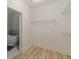 Walk-in closet with custom wire shelving and a view to the adjoining bathroom with tub at 379 Bohannon Rd, Grantville, GA 30220