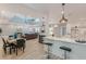 Open concept kitchen and dining area with modern lighting and wood-style flooring at 379 Bohannon Rd, Grantville, GA 30220