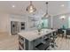 Modern kitchen featuring a large island with seating, stainless steel appliances, and wood flooring at 379 Bohannon Rd, Grantville, GA 30220