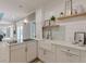 Modern white kitchen featuring a farmhouse sink, updated appliances, and ample counter space with stylish decor at 379 Bohannon Rd, Grantville, GA 30220