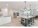 Modern kitchen with stainless steel appliances, white cabinets, large island, and wood flooring at 379 Bohannon Rd, Grantville, GA 30220